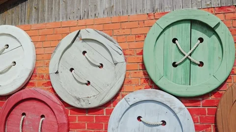 Cinematic view, large button decorations on red brick wall in Talsi Latvia Stock Footage 331967740