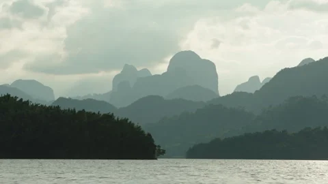 Cinematic View of Layered Limestone Karst Mountains in Morning Mist, Silhouetted 库存影片 335712784