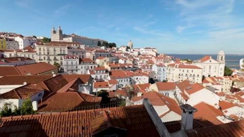 Cinematic view of Lisbon rooftops and historic buildings under blue sky. Vidéo 327685721