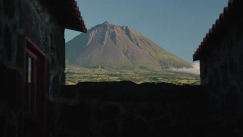 Cinematic View of Mount Pico Volcanic Cone Framed by Traditional Basalt Stone Stock-Footage 334665697
