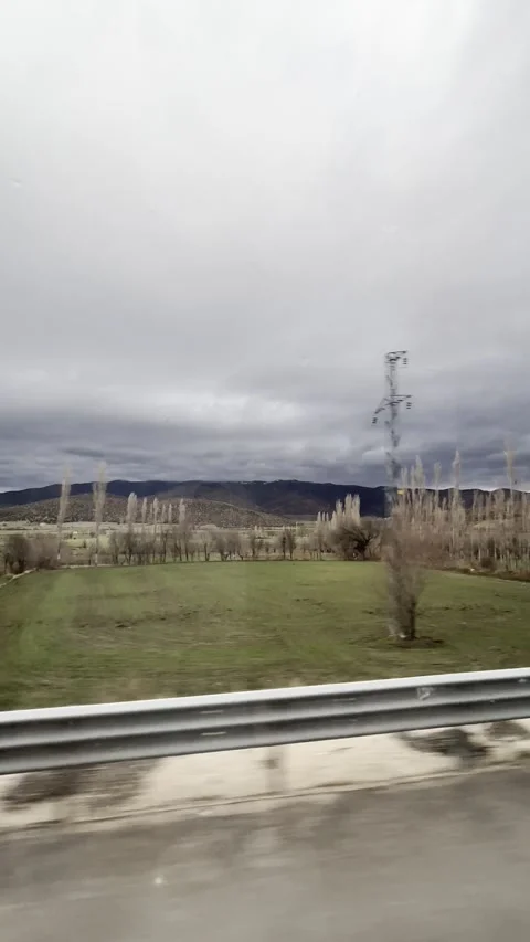 Cinematic View of Mountain Landscape from a Moving Vehicle Window Stock Footage 339491960