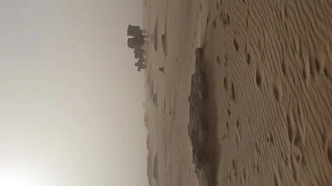 Cinematic view of a small caravan marching in the sand dunes with horses in a 스톡 동영상 336278936