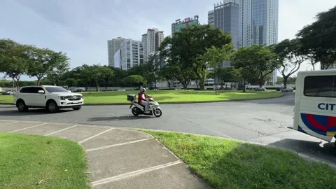 Cinematic View of Traffic in a Modern BGC Street 4k 60fps 動画素材 339207093