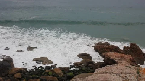 Cinematic view of wild sea waves washing over a rocky shore in Cantabrian co 스톡 동영상 334979867