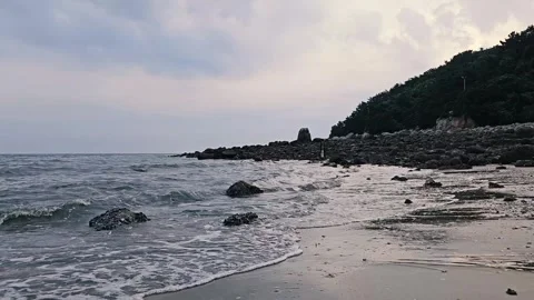 Cinematic Waves Rolling onto Rocky Coastline at Calm Seaside, 4K Vídeos de archivo 330166347