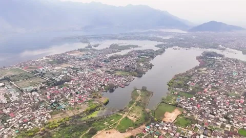 Cinematic wide aerial pullback over Srinagar, revealing the immense scale of Dal Stock Footage 333800557