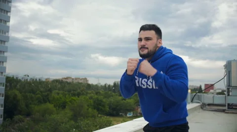 Cinematic Young Man Shadow Boxing On The Roof. Slow-Mo Stock Footage 64923028