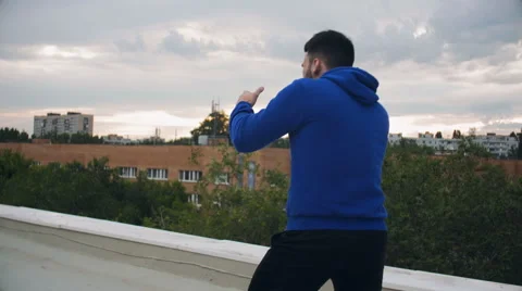 Cinematic Young Man Shadow Boxing On The Roof Video stock 64930156
