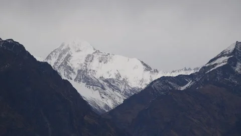 Cinematic Zoom Out Of Snow Capped Himalayan Peak Framed By Dark Mountains Stock Footage 340263227