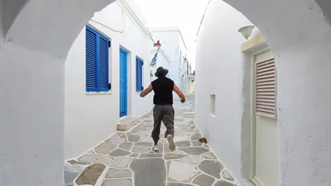 Cinematically running through lefkes in paros Stock Footage 281926611