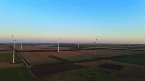 Cinematically smoothly revealing a huge wind turbine park on sunset Stock Footage 135241128