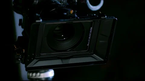 Cinematographer (camera operator) working with a cinema camera at night Video stock 100156681