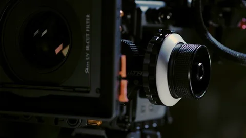 Cinematographer (camera operator) working with a cinema camera at night Stock Footage 100158798