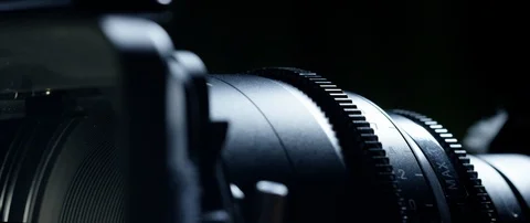 Cinematographer (camera operator) working with a cinema camera at night Video stock 100182106