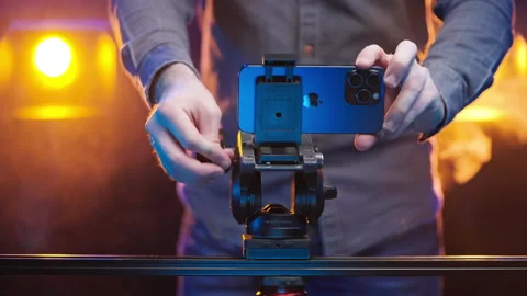 Cinematographer setting the iPhone 15 Pro Max on Tripod on professional set 4K Stock Footage 260064761