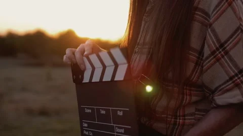 Cinematography take clapper in the hands of a man close-up in the setting sun Stock Footage 264511917