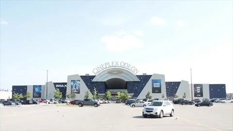 Cineplex odeon threatre theatre outside outdoors exterior with parking lot Stock Footage 249757318