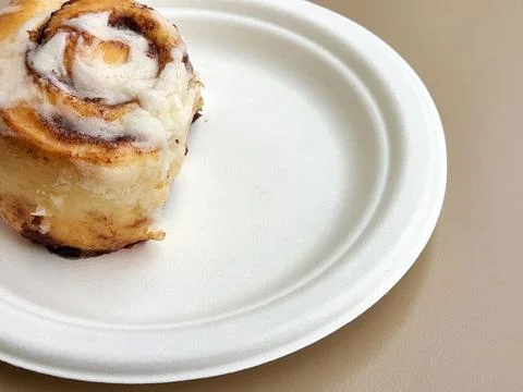Cinnabon cake. Sweet Cinnabon on a white plate Stock Photos