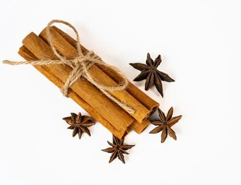 Cinnamon and star anise bundle on white surface Stock Photos