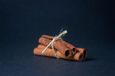 Cinnamon on a black background.  Stock Photos