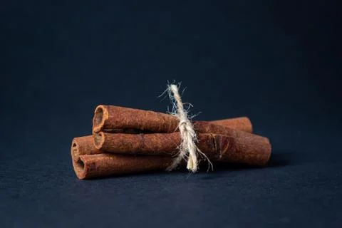 Cinnamon on a black background.  Stock Photos
