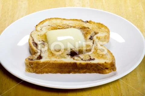 Cinnamon Bread Toast With Melted Pat Of Butter Stock Photos