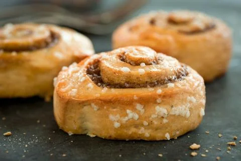 Cinnamon buns on rustic baking plate Stock Photos