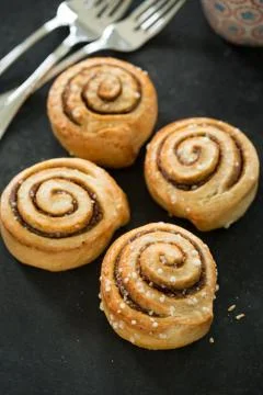 Cinnamon buns on rustic baking plate Stock Photos