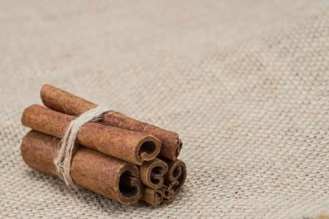 Cinnamon on a burlap Stock Photos