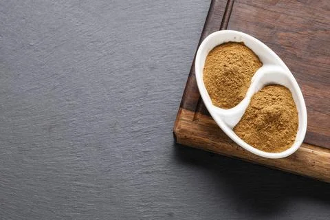 Cinnamon chips and powder on rustic wood Stock Photos