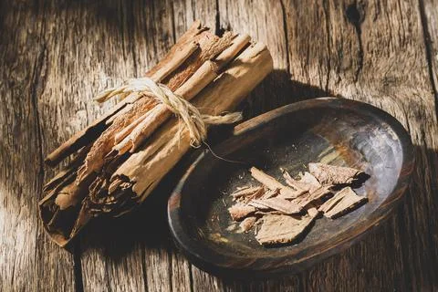 Cinnamon chips on rustic wood, close-up view Stock Photos