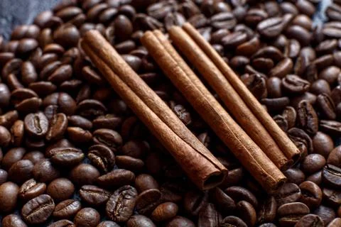 Cinnamon on coffee beans close-up Stock Photos