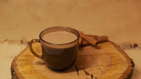 Cinnamon falling in cacao cup. Cocoa preparation with spices. Glass mug Stock Footage 140206915