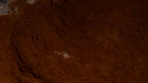 Cinnamon powder and bubbles. Close-up of mixer whipping milk smoothie with Stock Footage 84023529