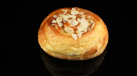 Cinnamon roll on black background rotating Stock Footage 55642806