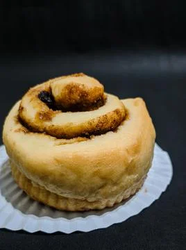 Cinnamon roll isolated on black background Stock Photos