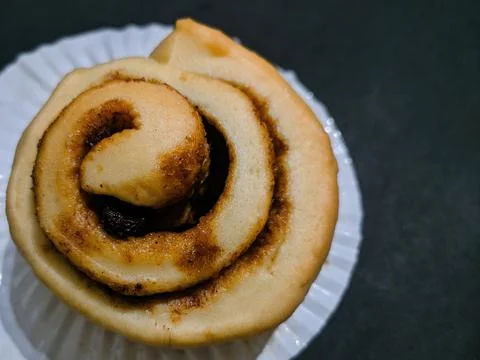 Cinnamon roll isolated on black background Stock Photos