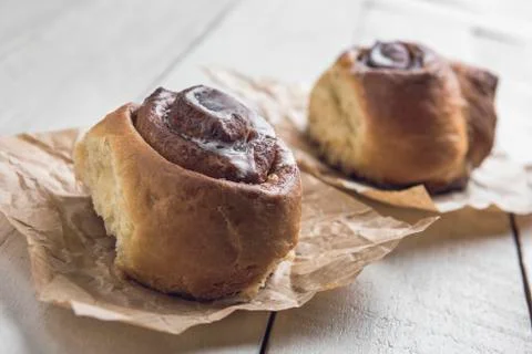 Cinnamon rolls closeup over a white wooden table. Stock Photos
