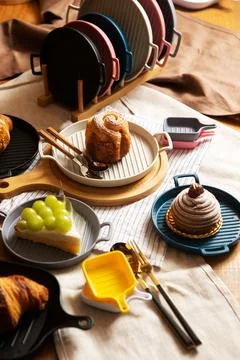 Cinnamon rolls on plate and tableware Stock Photos