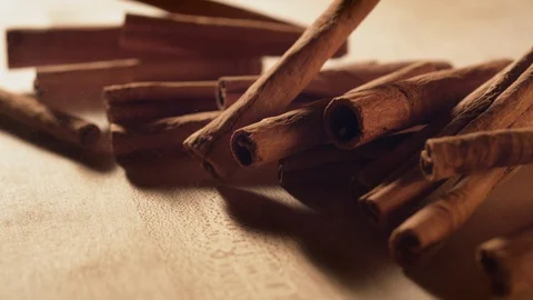 Cinnamon sticks falling on a table. Slow Motion. Stock Footage 128952648
