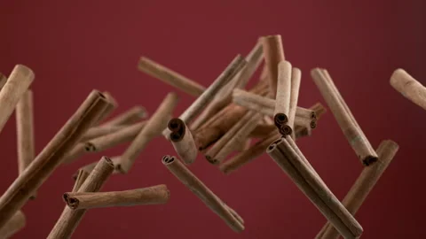 Cinnamon sticks flying on red background in slow motion.  Shot with Phantom Flex Stock Footage 162839698