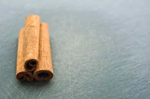 Cinnamon sticks lying on the table in the kitchen. Seasoning for Stock Photos