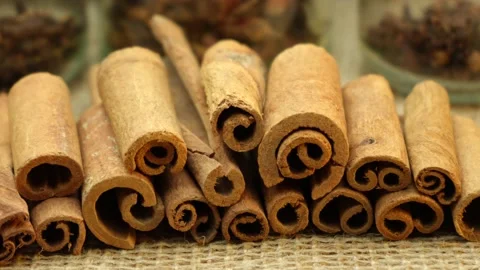 Cinnamon sticks on a surface covered with burlap. panorama close-up Stock Footage 229952089