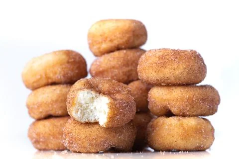 Cinnamon Sugar Mini Donuts in a stack on white background Stock Photos