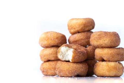 Cinnamon Sugar Mini Donuts in a stack on white background Stock Photos