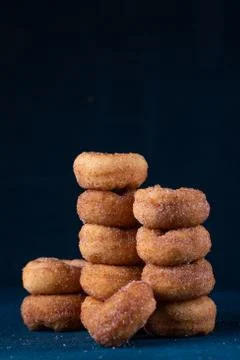 Cinnamon Sugar Mini Donuts in a stack on dark background with copy space Stock Photos