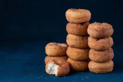 Cinnamon Sugar Mini Donuts in a stack on dark background with copy space Stock Photos