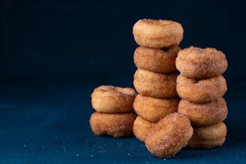 Cinnamon Sugar Mini Donuts in a stack on dark background with copy space Stock Photos