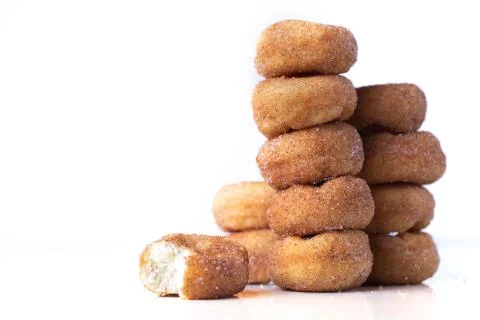 Cinnamon Sugar Mini Donuts in a stack on white background Stock Photos