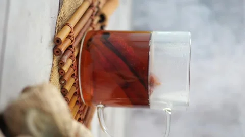 Cinnamon tea in clear mug on bamboo mat with ginger root herbal healthy inf.. Stock Footage 332044589